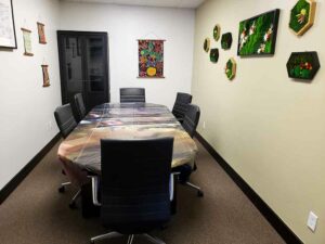 photo of a small conference room at the Thought Distillery office in Buena Vista, Colorado with art on the walls and six chairs