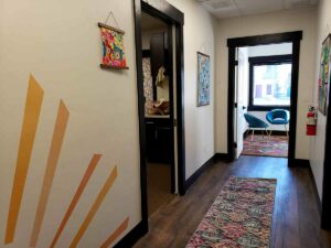 Thought Distillery office hallway photo with happy wall decals and art