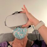 White woman wearing VR headset with flower mask